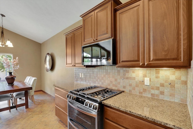 202 E Alexa Ct, Spokane, WA 99208 - kitchen featuring stainless steel appliances, decorative backsplash, a chandelier, vaulted ceiling, and brown cabinets