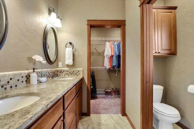 202 E Alexa Ct, Spokane, WA 99208 - bathroom with double vanity, tasteful backsplash, and a spacious closet