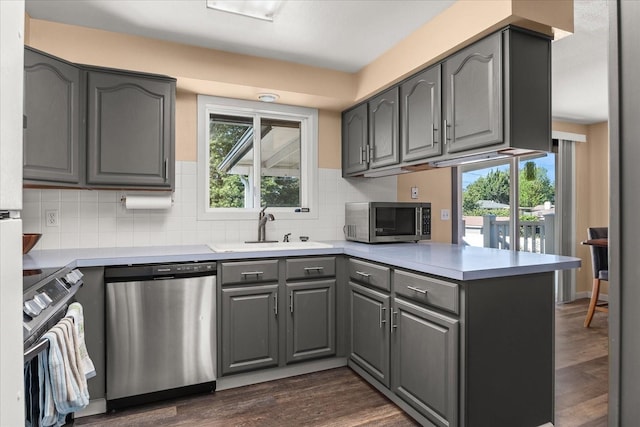14020 S Sharp Ave, Spokane Valley, WA 99216 - kitchen with stainless steel appliances, gray cabinetry, a peninsula, light countertops, and tasteful backsplash