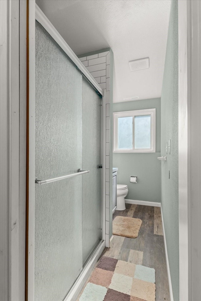 14020 S Sharp Ave, Spokane Valley, WA 99216 - bathroom featuring wood finished floors and a shower stall