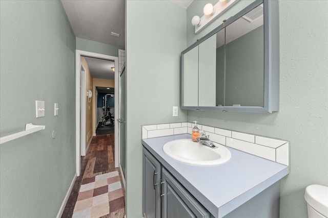 14020 S Sharp Ave, Spokane Valley, WA 99216 - bathroom featuring vanity and tasteful backsplash