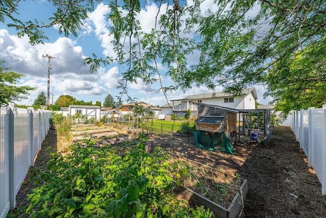 14020 S Sharp Ave, Spokane Valley, WA 99216 - fenced backyard with a vegetable garden, an outdoor structure, and exterior structure
