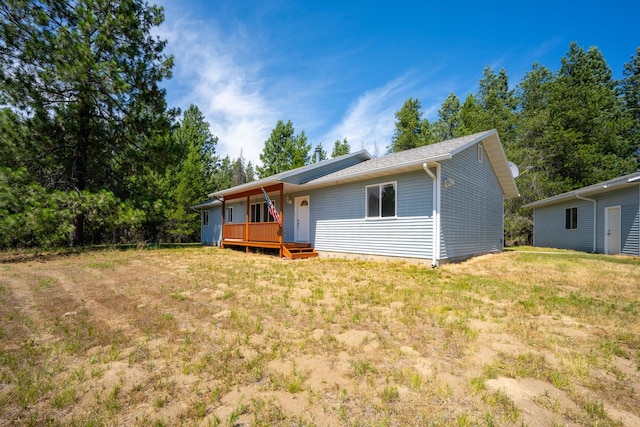 9801 Lakeshore Dr, Sagle, ID 83860 - back of house featuring a yard and covered porch