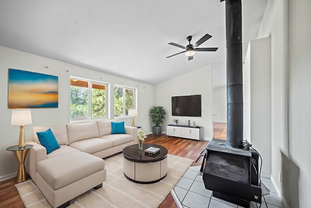 9801 Lakeshore Dr, Sagle, ID 83860 - living room featuring a wood stove, a ceiling fan, lofted ceiling, and wood finished floors