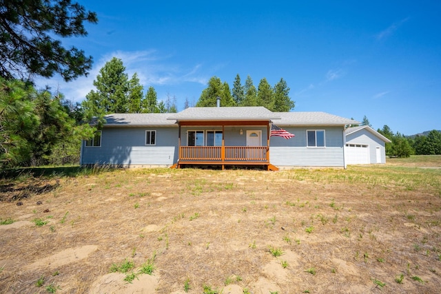 9801 Lakeshore Dr, Sagle, ID 83860 - back of house featuring a wooden deck and an outbuilding