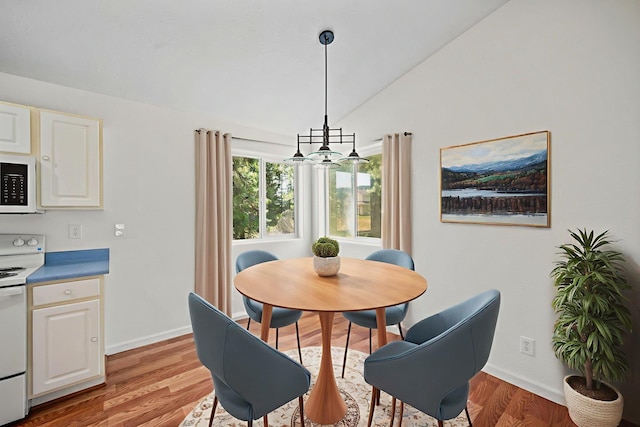 9801 Lakeshore Dr, Sagle, ID 83860 - dining area with light wood finished floors and lofted ceiling