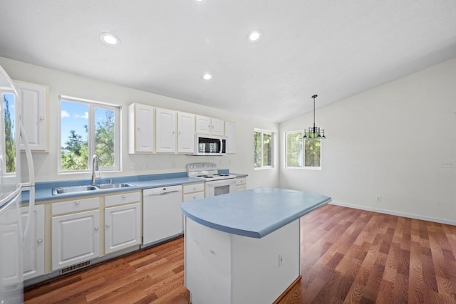 9801 Lakeshore Dr, Sagle, ID 83860 - kitchen featuring white appliances, white cabinetry, recessed lighting, lofted ceiling, and pendant lighting