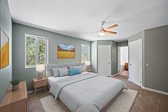 9801 Lakeshore Dr, Sagle, ID 83860 - bedroom featuring carpet, connected bathroom, and a ceiling fan