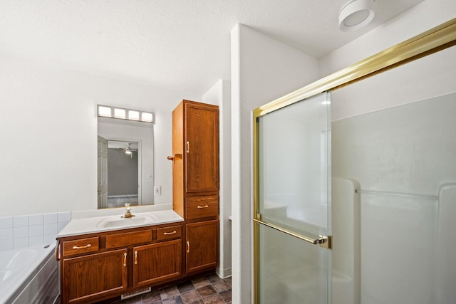 9801 Lakeshore Dr, Sagle, ID 83860 - full bath featuring a stall shower, vanity, a bath, and ceiling fan