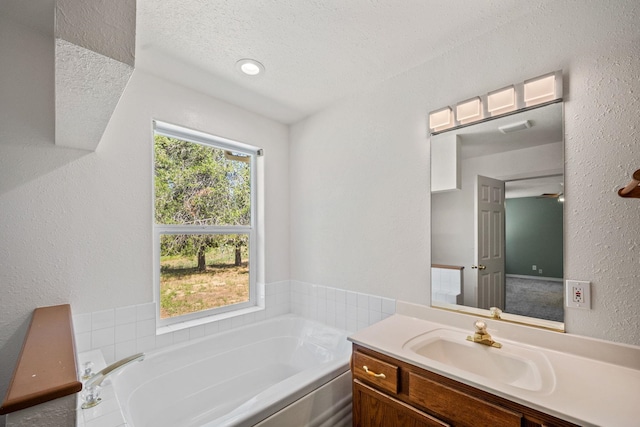 9801 Lakeshore Dr, Sagle, ID 83860 - full bath with vanity, a bath, a textured wall, and a textured ceiling