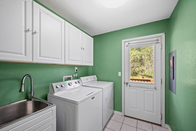 9801 Lakeshore Dr, Sagle, ID 83860 - laundry area with washing machine and clothes dryer, cabinet space, and light tile patterned floors