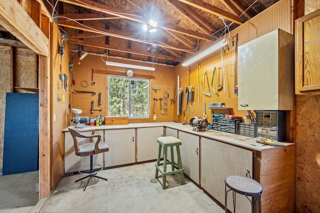 9801 Lakeshore Dr, Sagle, ID 83860 - miscellaneous room featuring a workshop area and unfinished concrete flooring