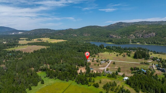 9801 Lakeshore Dr, Sagle, ID 83860 - aerial view of property's location with a heavily wooded area and a water and mountain view