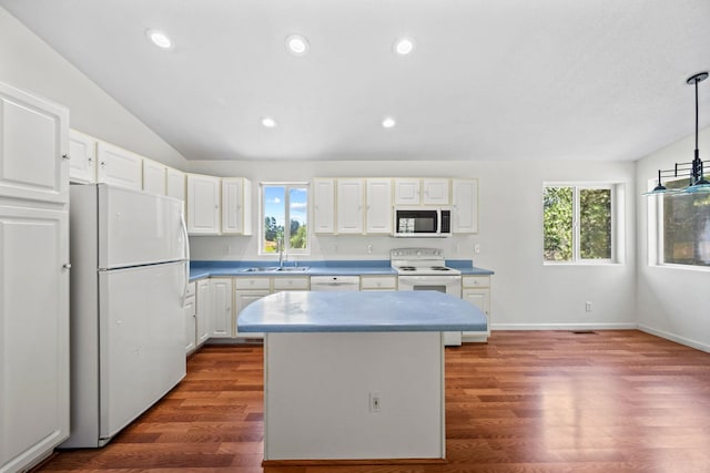 9801 Lakeshore Dr, Sagle, ID 83860 - kitchen with white appliances, healthy amount of natural light, dark wood finished floors, recessed lighting, and vaulted ceiling