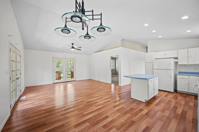 9801 Lakeshore Dr, Sagle, ID 83860 - kitchen featuring freestanding refrigerator, vaulted ceiling, white cabinets, light wood-style floors, and a ceiling fan