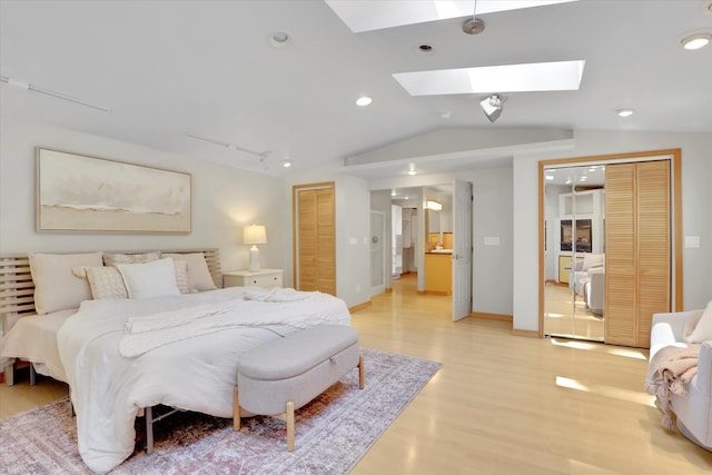 2714 E 11th Ave, Spokane, WA 99202 - bedroom with light wood-type flooring, a skylight, lofted ceiling, recessed lighting, and two closets