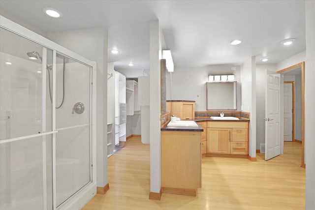 2714 E 11th Ave, Spokane, WA 99202 - full bathroom with wood finished floors, a shower stall, vanity, and recessed lighting