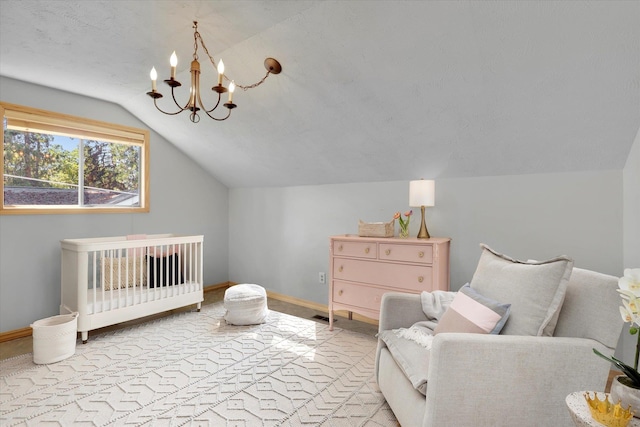 2714 E 11th Ave, Spokane, WA 99202 - bedroom featuring vaulted ceiling, a chandelier, and a crib