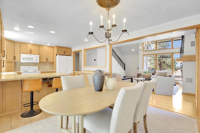 2714 E 11th Ave, Spokane, WA 99202 - dining area with a chandelier, recessed lighting, ornamental molding, and stairs