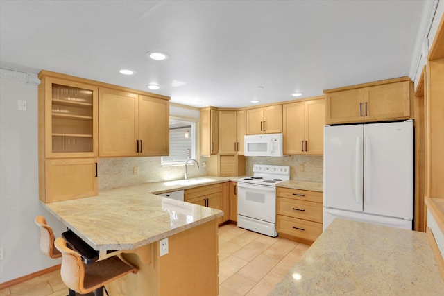 2714 E 11th Ave, Spokane, WA 99202 - kitchen with white appliances, light brown cabinetry, a peninsula, tasteful backsplash, and recessed lighting