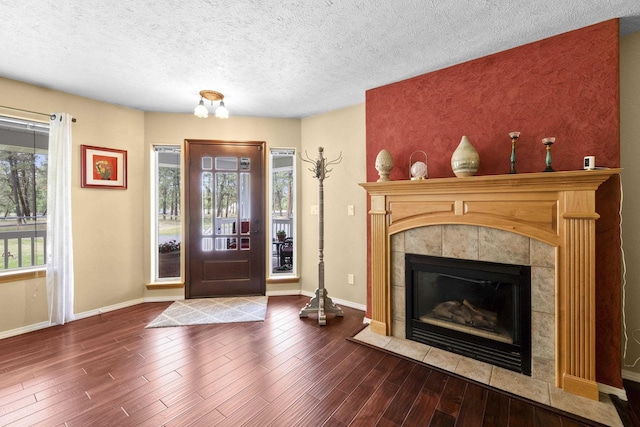 7905 W Seven Mile Rd, Nine Mile Falls, WA 99026 - foyer entrance with a fireplace, wood finished floors, and a textured ceiling