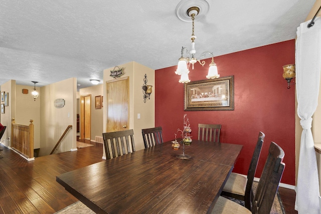 7905 W Seven Mile Rd, Nine Mile Falls, WA 99026 - dining space with wood-type flooring, a chandelier, and a textured ceiling