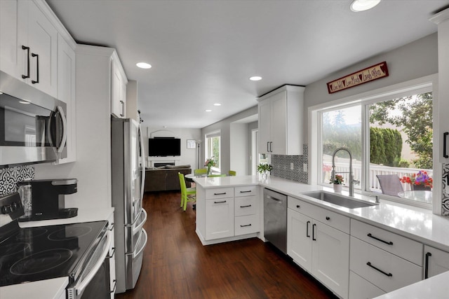 4116 S S Tenfel Ln, Spokane, WA 99223 - kitchen featuring appliances with stainless steel finishes, light countertops, white cabinetry, dark wood-type flooring, and recessed lighting