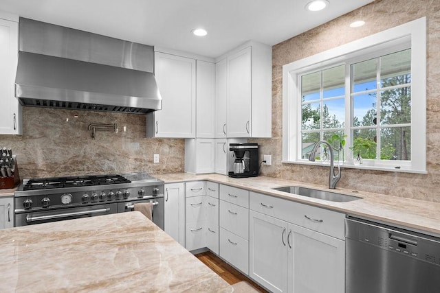 3929 S Best Ct, Veradale, WA 99037 - kitchen with stainless steel appliances, wall chimney range hood, white cabinets, tasteful backsplash, and recessed lighting