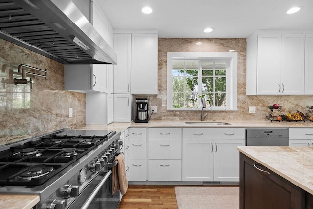 3929 S Best Ct, Veradale, WA 99037 - kitchen featuring ventilation hood, high end stainless steel range oven, dishwasher, decorative backsplash, and white cabinetry