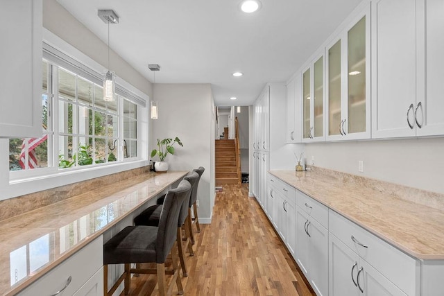 3929 S Best Ct, Veradale, WA 99037 - kitchen with glass insert cabinets, pendant lighting, white cabinetry, light wood-style floors, and recessed lighting