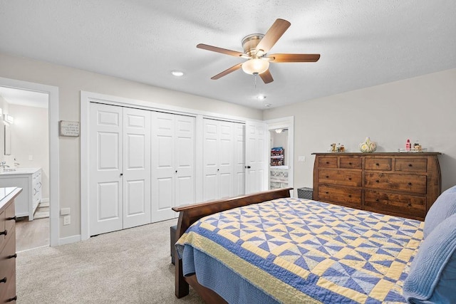 3929 S Best Ct, Veradale, WA 99037 - carpeted bedroom featuring multiple closets, ensuite bathroom, recessed lighting, and ceiling fan