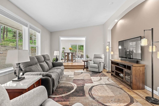 3929 S Best Ct, Veradale, WA 99037 - living room with lofted ceiling, light wood-style flooring, healthy amount of natural light, and arched walkways