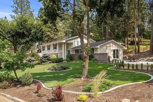 3929 S Best Ct, Veradale, WA 99037 - view of front of home featuring a front yard, a patio area, and brick siding