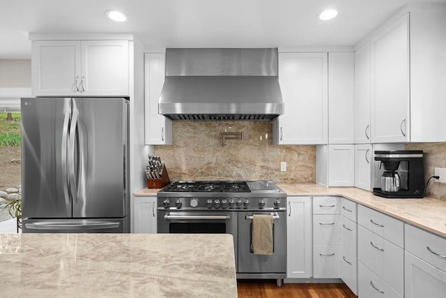 3929 S Best Ct, Veradale, WA 99037 - kitchen with stainless steel appliances, wall chimney exhaust hood, white cabinets, backsplash, and recessed lighting