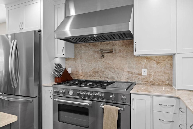 3929 S Best Ct, Veradale, WA 99037 - kitchen featuring appliances with stainless steel finishes, wall chimney exhaust hood, light countertops, white cabinets, and backsplash