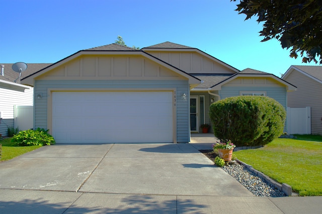 1636 E Vanetta Ln, Spokane, WA 99217 - single story home with board and batten siding, a front yard, driveway, a garage, and a shingled roof