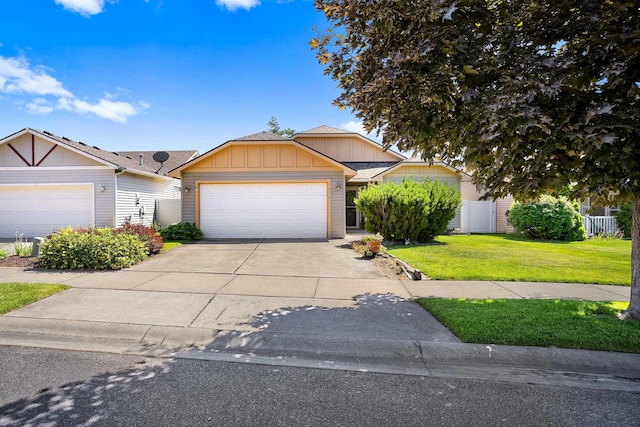 1636 E Vanetta Ln, Spokane, WA 99217 - view of front facade featuring an attached garage, concrete driveway, and board and batten siding