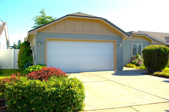 1636 E Vanetta Ln, Spokane, WA 99217 - view of front facade featuring board and batten siding, driveway, and a garage