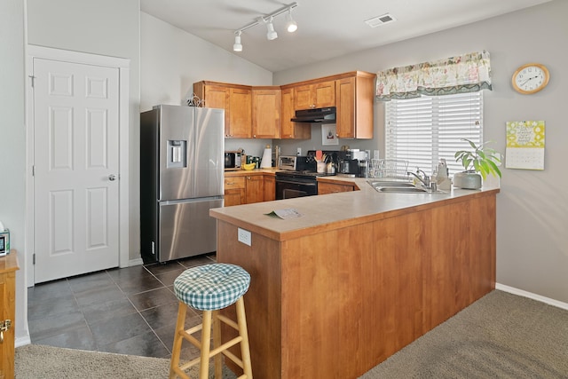1636 E Vanetta Ln, Spokane, WA 99217 - kitchen with stainless steel fridge with ice dispenser, black electric range oven, under cabinet range hood, light countertops, and a peninsula