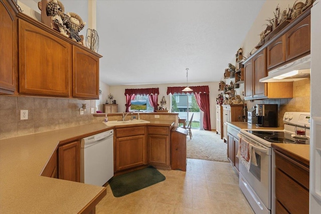 14316 E 31st Ln, Veradale, WA 99037 - kitchen featuring white appliances, under cabinet range hood, a peninsula, and brown cabinets