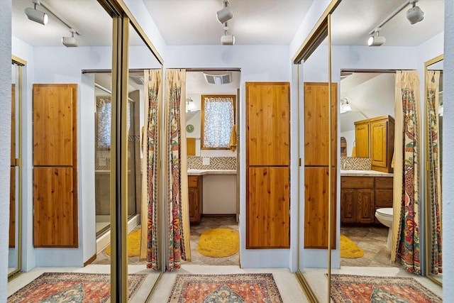 5003 N Normandie St, Spokane, WA 99205 - full bathroom with rail lighting, vanity, and a shower with shower curtain