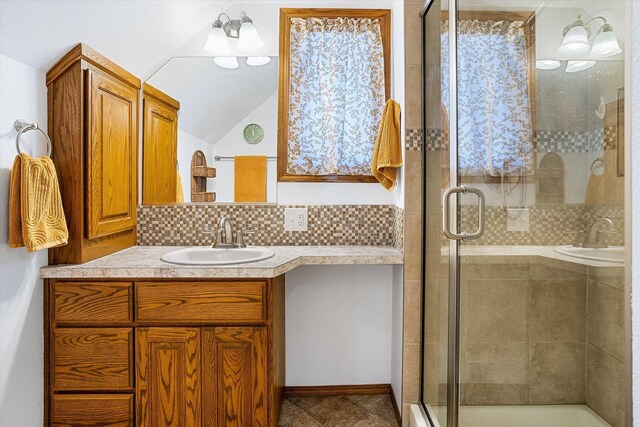 5003 N Normandie St, Spokane, WA 99205 - bathroom featuring vanity, a stall shower, tasteful backsplash, and vaulted ceiling