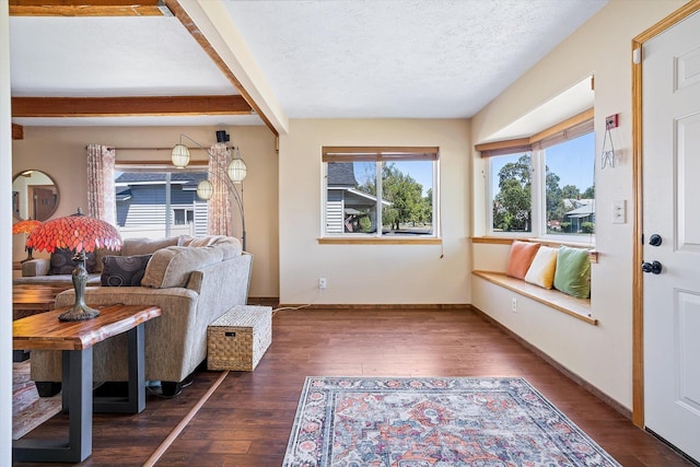 5003 N Normandie St, Spokane, WA 99205 - living area with healthy amount of natural light, dark wood-style floors, beam ceiling, and a textured ceiling