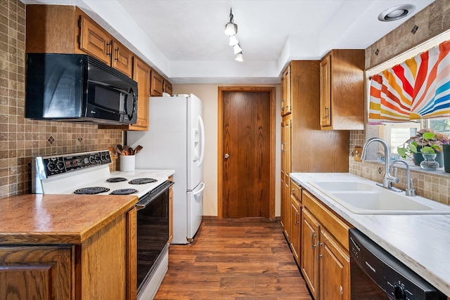 5003 N Normandie St, Spokane, WA 99205 - kitchen with black appliances, dark wood finished floors, tasteful backsplash, brown cabinetry, and light countertops