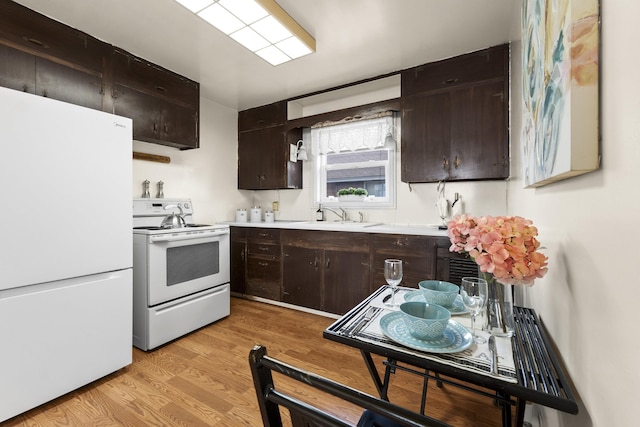 5218 E Commerce Ave, Spokane, WA 99212 - kitchen featuring white appliances, light countertops, dark brown cabinetry, and light wood-style flooring