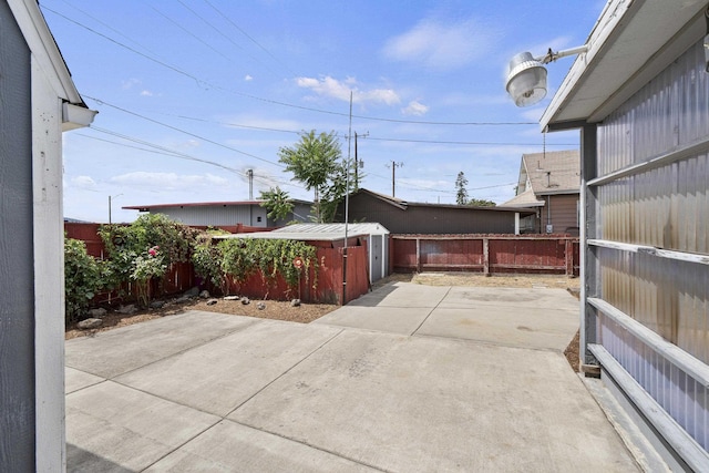 5218 E Commerce Ave, Spokane, WA 99212 - fenced backyard featuring a patio area and a storage unit