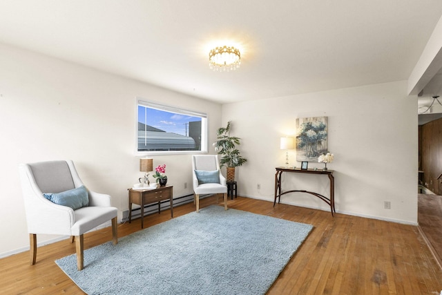 5218 E Commerce Ave, Spokane, WA 99212 - sitting room with a baseboard radiator, wood finished floors, and a chandelier