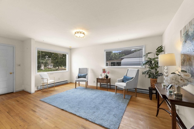 5218 E Commerce Ave, Spokane, WA 99212 - living area with a baseboard radiator, plenty of natural light, and wood finished floors