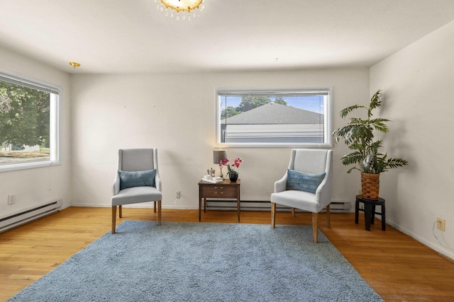 5218 E Commerce Ave, Spokane, WA 99212 - living area featuring plenty of natural light, wood finished floors, and a baseboard heating unit