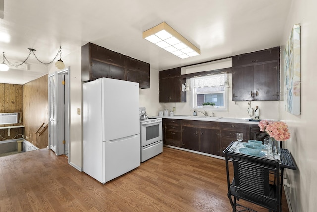 5218 E Commerce Ave, Spokane, WA 99212 - kitchen featuring white appliances, dark brown cabinets, light countertops, and wood finished floors